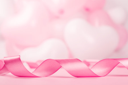 Valentine day background with pink curly satin ribbon and many balloons with copy space for textの写真素材