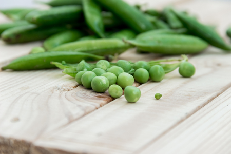 Peas and pods of peas on a light background. Concept of healthy eating.の写真素材