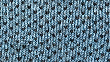 knitted fabric texture background with dark polka dots. Blue knitted warm background