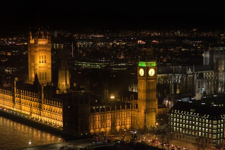 Aerial view of lights on Thames, Illuminated Big Ben and Houses of parliament during eveningの写真素材