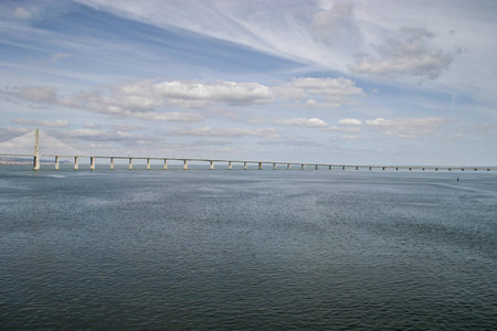 Lisbon, Portugal - September 17, 2006: River Tagus with Vasco da Gama Bridge and dramatic sky in background.のeditorial素材