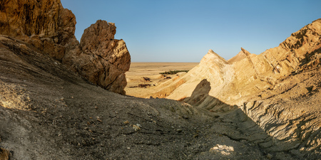 Dry rocks near Chebika oasis with desert in background lit by midday sun. Atlas Mountains, Tunisia.の写真素材