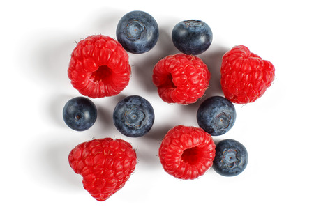 Top view - blueberries and raspberries isolated on white background.