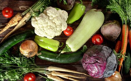 Top down view, heap of various vegetables on dark wooden boardの写真素材