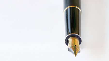 Golden coloured fountain pen nib detailed macro closeup - all imperfections and corrosion visible on metal.の写真素材