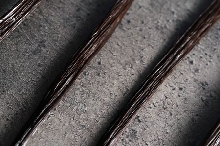 Bourbon vanilla sticks on stone like board, close up photo from aboveの写真素材