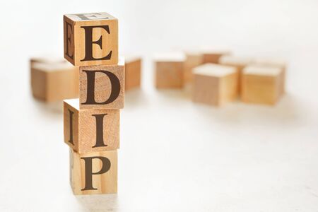Four wooden cubes arranged in stack with letters EDIP meaning Explain, demonstrate, imitate, practice on them, space for text image at down right corner.の写真素材