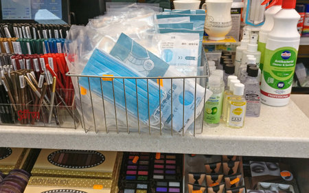 London, United Kingdom - April 22, 2020: Disposable blue virus masks displayed on shelves at shop in Lewisham, during coronavirus covid-19 outbreak. Masks are not mandatory in UK and only few wear itのeditorial素材