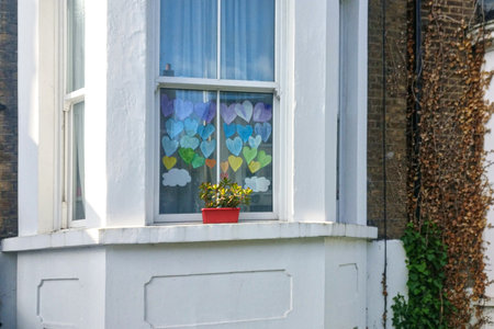 London, United Kingdom - April 29, 2020: Hand made colourful paper hearts displayed displayed at house in Lewisham as thanks to NHS and essential workers, during coronavirus covid-19 outbreak.のeditorial素材