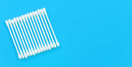 Cotton buds or swabs arranged in square on light blue desk, view from above, space for text right...