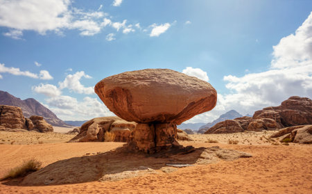 Mushroom shaped rock at Wadi Rum desert, bright sun shines on mountains backgroundの写真素材