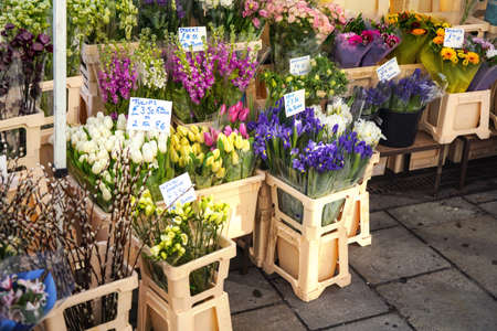 Various flowers on display at street flower stall in London market, Bouquets displayed inside...