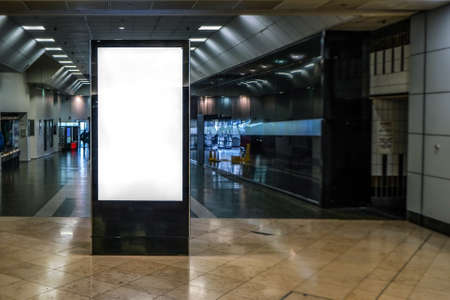 Ad screen mock up at small shopping centre, dark corridor leading outside in backgroundの写真素材