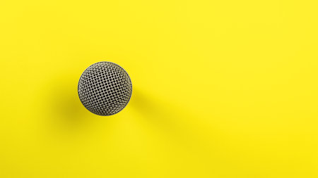 Microphone on yellow board, direct top down view, only ball with grid visible making so it looks abstract.の写真素材