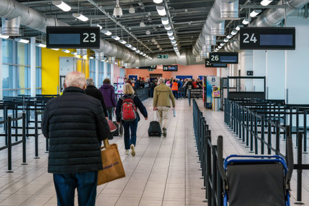 London, United Kingdom - February 05, 2019: Passengers walking in departure hall building to gate desk for their flight, at Luton Airport. LTN is 5th busiest in United Kingdom.のeditorial素材