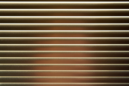 Detail on metal window blinds, some light reflects on, dust visible, abstract geometric backgroundの写真素材