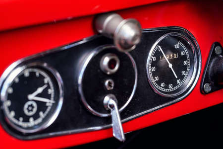 Speedometer on vintage red car, closeup detail