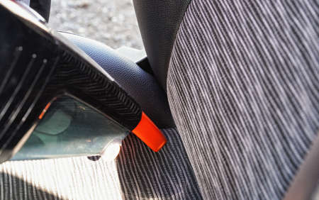 Car interior - seats, cleaned from dust with small orange portable vacuum cleanerの写真素材