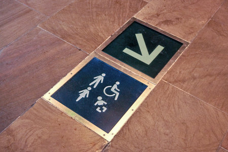 Toilets and baby changing room sign with arrow symbol on the floor of shopping mallの写真素材