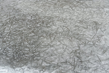 Ice on frozen river forming crystal like structures, closeup macro detail from above - abstract...