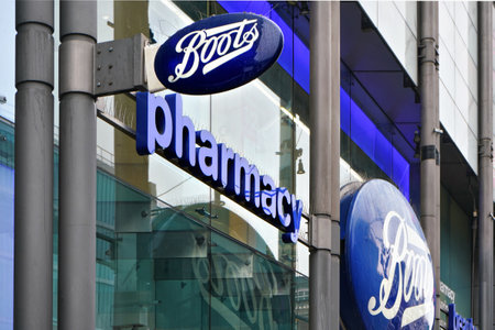 London, United Kingdom - February 01, 2019: Typical blue oval sign at one of many Boots branches in London. Boots is a health and beauty pharmacy chain in UK and few other countriesのeditorial素材