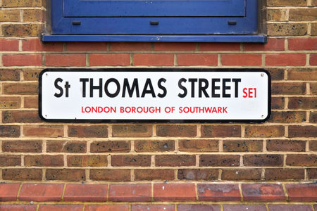 London, United Kingdom - February 01, 2019: Typical London road avenue at St Thomas Street placed on brown brick wall, closeup detailのeditorial素材