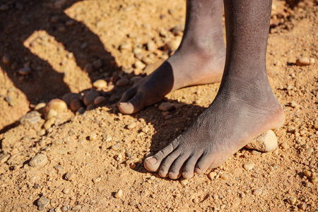 African man bare feet on the ground, closeup detailの写真素材