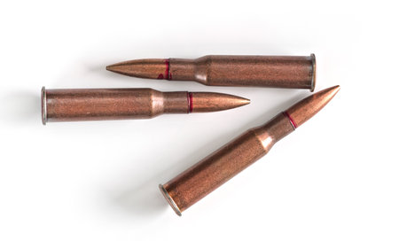 Three copper machine gun bullets isolated on white background