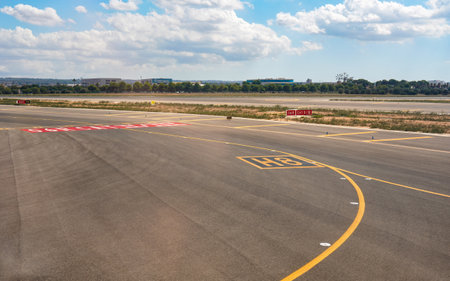Palma, Spain - September 25, 2019: Yellow direction lines on ground of Mallorca airport, sun shines to empty runways nearのeditorial素材