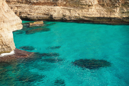 Clear blue green sea water, rocky cliffs around - nice sunny day at Ansa de s'Estri, Mallorcaの写真素材