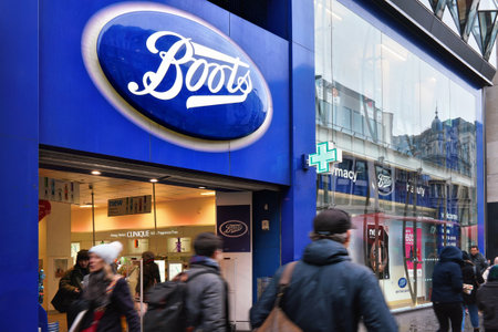 London, United Kingdom - February 01, 2019: Typical blue oval sign at one of many Boots branches in London. Boots is a health and beauty pharmacy chain in UK and few other countriesのeditorial素材