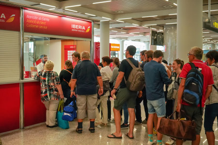 Palma, Spain - September 25, 2019: Passengers waiting in queue at Iberia customer services kiosk. Iberia airlines are main airline in Spain, established 1927のeditorial素材
