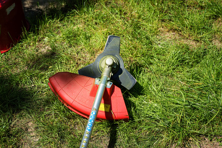 Grass cutter / brush cutter for trimming overgrown grassの写真素材