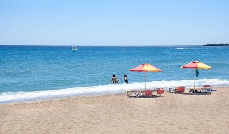 Young girls having fun on Stegna beach (RHODES, GREECE)の写真素材