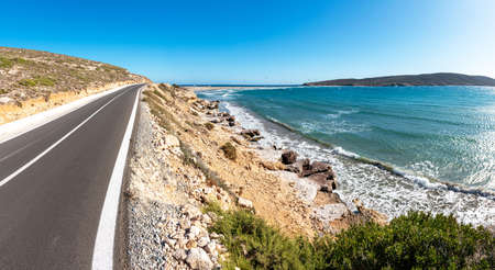 Coastline road to Prasonisi beach with kite surfers in background (Rhodes, Greece)の写真素材