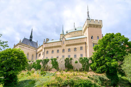 View of neogothic Bojnice castle with small fortification wall from Castle park (Bojnice, Slovakia)のeditorial素材
