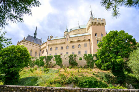 View of neogothic Bojnice castle with small fortification wall from Castle park (Bojnice, Slovakia)のeditorial素材