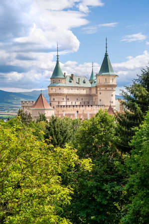 View of neogothic Bojnice castle over treetops of Castle park (Bojnice, Slovakia)のeditorial素材