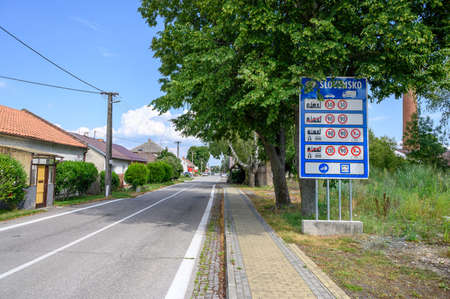 Big blue board with speed limits in Slovakia on entrance road to village Zahorska Ves (SLOVAKIA)の写真素材
