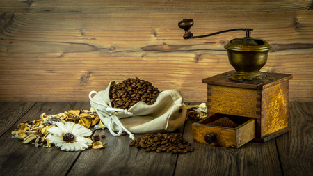 Still life with coffee, grinder and flowers. Vintage style.の写真素材