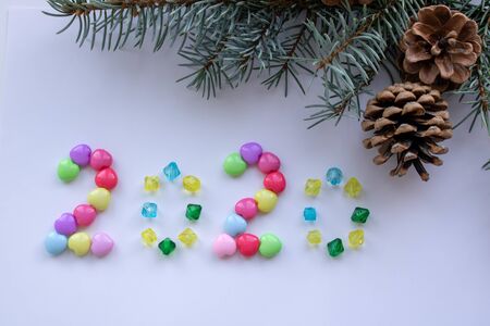 Ginger biscuits of the form of numbers and 2020 new year ginger cookies on grey background. Top...