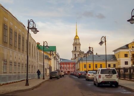 Russia, Yaroslavl region, Rybinsk. City street in autumn with houses, road and cathedralの写真素材