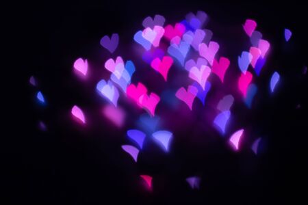 Abstract beautiful blurred violet-purple-lilac and pink colored of swirling heart shaped bokeh from ornamental lights flickering in the park. Background for Valentine s day or Love or Romance concept.の写真素材