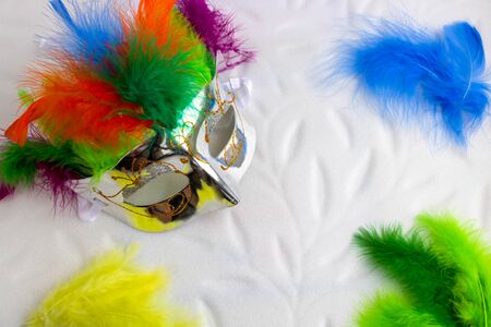 Carnival mask with multicolored feathers isolated on a white background.の写真素材