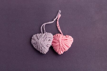 Pink and lilac knitting yarn heart shaped. Valentines day minimal concept. Greeting card with heart...