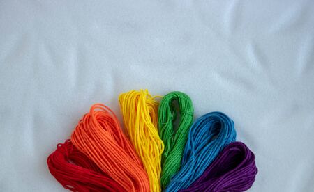 Sewing threads as a multicolored background close up.