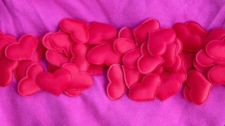 Hearts on a pink background, top view. Pink background with hearts for Valentine's day or wedding.