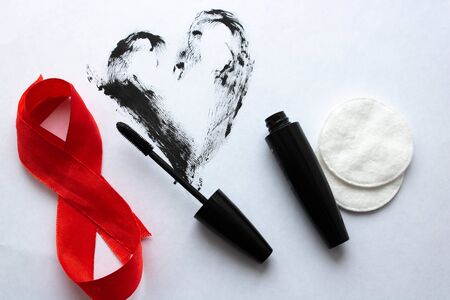 Black mascara with curler on white background.