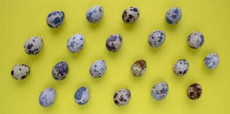 Quail eggs on natural linen background. Collection of quail eggs, easter pattern. Flat lay, top view. Easter concept.の写真素材