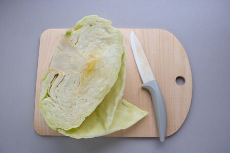chopped fresh cabbage closeup on a wooden board, next to a knife, with copy spaceの写真素材